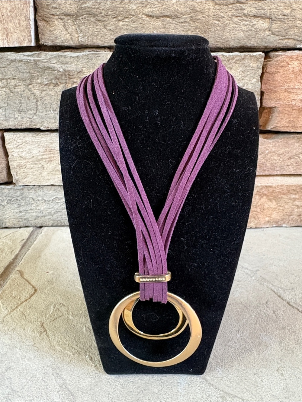 Chico’s purple chord necklace with gold circle pendant
